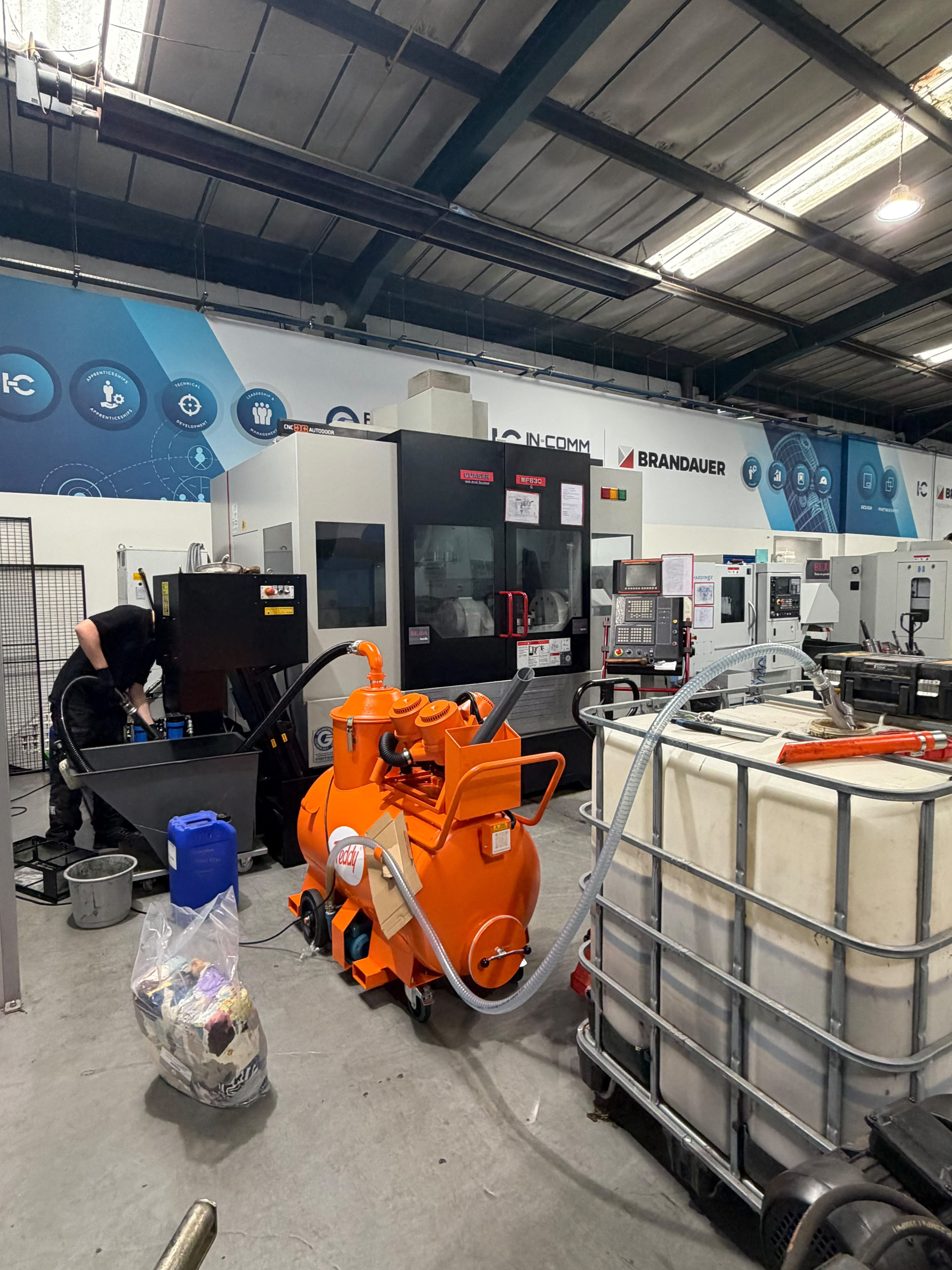 King Machine Tool Services Freddy coolant filtration unit and IBC on site alongside a CNC machining centre.